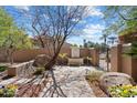 Beautifully landscaped front yard with a tranquil fountain, lush greenery, and a charming walkway leading to the entrance at 4448 E Camelback Rd # 16, Phoenix, AZ 85018