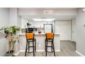 Bright kitchen with modern white cabinets, a breakfast bar, and light-colored countertops at 4730 W Northern Ave # 1102, Glendale, AZ 85301
