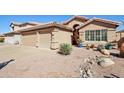 Charming home featuring desert landscaping, a two-car garage, and a decorative arched entryway at 5102 E Libby St, Scottsdale, AZ 85254