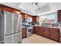 Updated kitchen featuring stainless steel appliances, granite countertops, and ample cabinet space at 5905 N 83Rd St, Scottsdale, AZ 85250