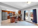 Modern kitchen with stainless steel appliances, granite countertops, and island seating at 5905 N 83Rd St, Scottsdale, AZ 85250