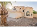 Charming two-story home featuring a two-car garage, desert landscaping, and a neutral color palette at 62 N Amber Ct, Chandler, AZ 85225