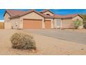 Charming single-story home with a three-car garage, desert landscaping, and mature vegetation at 730 E Tanya Trl, Phoenix, AZ 85086