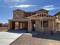 New construction home with a concrete driveway and framed walls during building process at 7441 W Buckhorn Trl, Peoria, AZ 85383