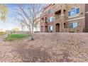 Multi-story condo building featuring colorful facades, private balconies, and desert landscaping at 900 S 94Th St # 1203, Chandler, AZ 85224