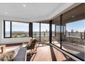 Bright living area boasts floor-to-ceiling windows offering expansive city views, hardwood floors, and stylish seating at 1040 E Osborn Rd # 1004, Phoenix, AZ 85014