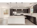 Beautiful kitchen featuring stainless steel appliances, a large island, and stylish pendant lighting at 11615 W Beck Ave, Youngtown, AZ 85363