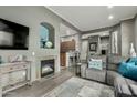 Open concept living room includes stylish decor, a fireplace, and seamless flow into the kitchen at 11640 N Tatum Blvd # 3048, Phoenix, AZ 85028