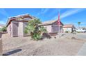 Charming single-story home with neutral stucco, desert landscaping, and a two-car garage in a quiet residential neighborhood at 123 S Lucia Ln, Casa Grande, AZ 85194
