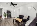 Open-concept living room featuring white walls, modern furniture, and hardwood floors at 1254 W Manhatton Dr, Tempe, AZ 85282