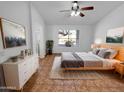 Main bedroom featuring ceiling fan, window, and a decorative mirror at 12914 W Wilshire Dr, Avondale, AZ 85392