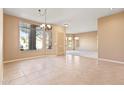 Bright living space features neutral tones, tile flooring, and large windows offering abundant natural light at 1313 W Straford Ave, Gilbert, AZ 85233