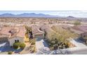 Expansive aerial view showing the community, nearby mountains, and home's desert landscaping at 15313 S 180Th Ave, Goodyear, AZ 85338