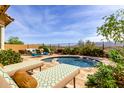 Resort style pool deck features lounge chairs, lush landscaping, and desert views at 15313 S 180Th Ave, Goodyear, AZ 85338