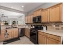 Well-equipped kitchen with stainless steel appliances and light wood cabinets at 17168 W Saguaro Ln, Surprise, AZ 85388