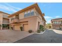 Exterior view of townhome featuring multiple garage doors and neutral color scheme at 19777 N 76Th St # 2150, Scottsdale, AZ 85255
