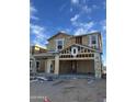 New construction showing the framing of a two-story house with garage under a sunny, blue sky at 2075 E Bucking Bronco Dr, San Tan Valley, AZ 85140