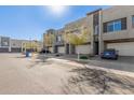 Street view of modern townhomes featuring multiple garages and desert landscaping at 25318 N 19Th Dr, Phoenix, AZ 85085