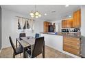 A cozy dining area features wood cabinets and tile floors with a window for natural light at 2940 W Townley Ave, Phoenix, AZ 85051