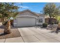 Inviting home with a spacious driveway, desert landscaping, and an attached two-car garage at 4091 S Dew Drop Ct, Gilbert, AZ 85297
