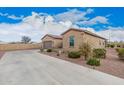 Well-manicured desert landscaping complements the exterior of this home with a spacious driveway and convenient garage access at 41553 W Springtime Rd, Maricopa, AZ 85138