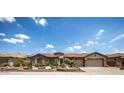 Stunning exterior view of home showcasing manicured landscaping, decorative rock, and a welcoming front yard at 41607 N Club Pointe Dr, Phoenix, AZ 85086