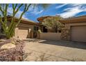Desert home with a circular entry and beautiful desert landscaping at 42211 N Long Cove Way, Anthem, AZ 85086