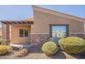 Side of house featuring brick accents, low maintenance gravel landscaping, and covered entry way at 6202 E Mckellips Rd # 171, Mesa, AZ 85215
