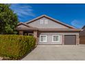 Charming single-Gathering home featuring a two-car garage, manicured landscaping and a tile roof at 6456 E Orion St, Mesa, AZ 85215