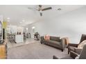 Open-concept living space with a modern sofa and adjacent kitchen area at 6513 W Latona Rd, Laveen, AZ 85339