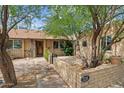 Inviting entryway featuring a brick facade, secure gate, and desert landscaping at 7226 E Virginia Ave, Scottsdale, AZ 85257