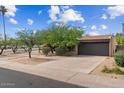 Street view of a single-story home with mature landscaping and an extended driveway at 7226 E Virginia Ave, Scottsdale, AZ 85257