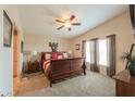 Comfortable main bedroom with a king-size bed, ceiling fan, and neutral decor at 918 E Lincolnwood Cir, Casa Grande, AZ 85194