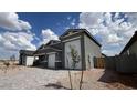 Single Gathering home with a spacious two car garage, desert landscaping, and brick driveway at 15769 W Cheryl Dr, Waddell, AZ 85355