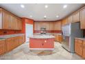 A kitchen with stainless steel appliances, ample counter space, and a center island at 18457 W Ivy Ln, Surprise, AZ 85388