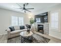 Bright living room featuring modern furniture, a stylish fireplace, and large windows with plantation shutters at 1926 W Holly St, Phoenix, AZ 85009