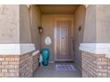 Elegant entryway featuring a decorative metal door, brick pillars, and a 'Welcome' mat, creating an inviting entrance at 20729 E Canary Way, Queen Creek, AZ 85142