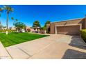 Single Gathering home featuring a well-maintained lawn and desert landscaping at 25261 S Berry Brook Dr, Sun Lakes, AZ 85248