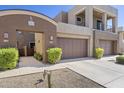 Contemporary townhouse featuring a two-car garage, well-maintained landscaping, and a private entrance at 27000 N Alma School Pkwy # 1024, Scottsdale, AZ 85262