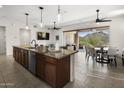 Open kitchen with a large island, modern appliances, and seamless flow to the dining and living areas at 27000 N Alma School Pkwy # 1024, Scottsdale, AZ 85262