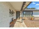 Charming covered front porch with seating and decorative wall art at 2920 E Villa Maria Dr, Phoenix, AZ 85032