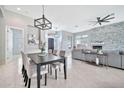 Open-concept dining room and living room featuring modern light fixtures at 3138 W Ravina Ln, Anthem, AZ 85086