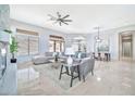 Open-concept living room features modern decor, a ceiling fan, and abundant natural light at 3138 W Ravina Ln, Anthem, AZ 85086