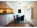Cozy dining area with a modern table set, complemented by bright natural light from the nearby window at 3150 E Beardsley Rd # 1105, Phoenix, AZ 85050