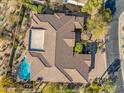 An aerial view of a home, showcasing the roof, pool and surrounding landscaping at 37170 N Granite Creek Ln, Carefree, AZ 85377