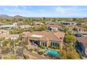 An aerial view of the backyard showcasing a pool, fountain, and desert landscaping at 37170 N Granite Creek Ln, Carefree, AZ 85377