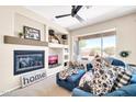 Cozy living room with fireplace, built-in shelves, and lots of natural light at 41229 N Belfair Way, Anthem, AZ 85086