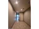 Hallway with neutral paint and tile flooring at 4250 N 87Th Ln, Phoenix, AZ 85037