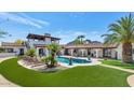Lush backyard with a sparkling pool, lounge seating, and well-manicured turf at 4726 E Sierra Vista Dr, Paradise Valley, AZ 85253