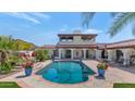 Backyard pool surrounded by patio, lounge chairs, and lush landscaping at 4726 E Sierra Vista Dr, Paradise Valley, AZ 85253